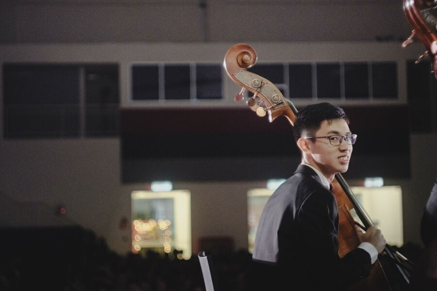 Ventus on stage with his double bass, glancing back at the camera